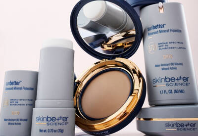 skinbetter science mineral sunscreen products beside an open gold compact mirror revealing pressed powder